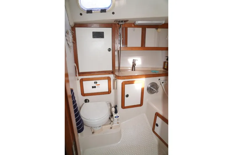 Slide: The Image of Bathroom interior of 2000 Catalina 36 MkII sailboat with wooden accents and compact design. - 32