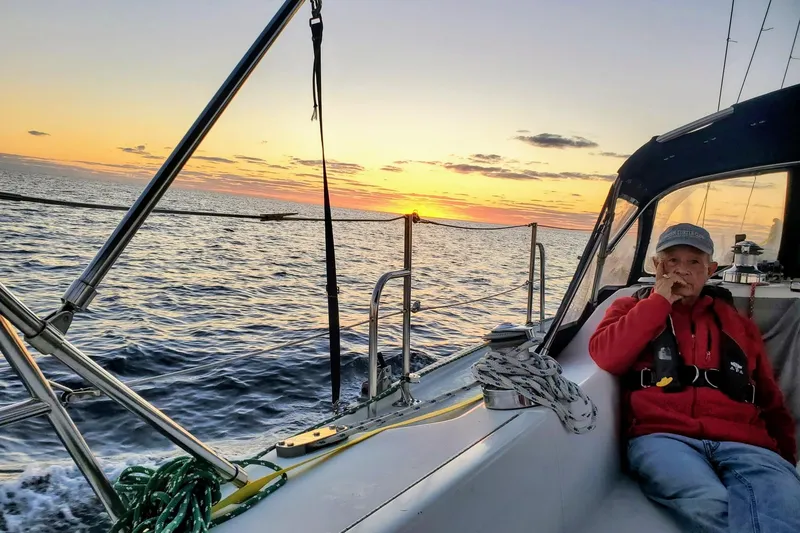 Slide: The Image of Man relaxing on a 2000 Catalina 36 MkII sailboat at sunset. - 42