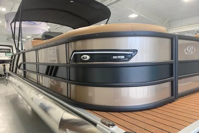 Slide: The Image of 2026 Bentley Pontoons Elite 253 Swingback, luxury pontoon boat with sleek design in showroom. - 2