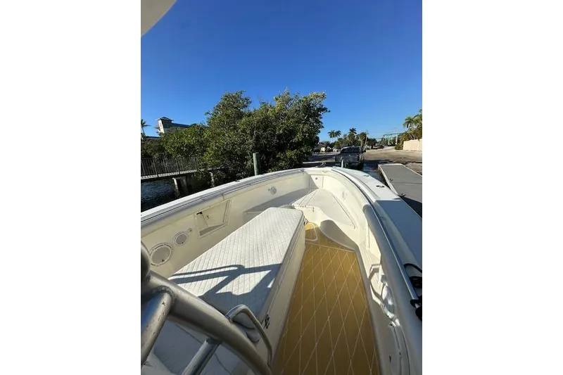 Slide: The Image of 2007 Hydra-Sports Vector 3300 CC boat docked near lush greenery and clear blue sky. - 11