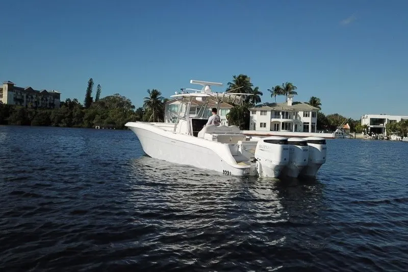 Slide: The Image of 2007 Hydra-Sports Vector 3300 CC boat on calm water near waterfront homes. - 2