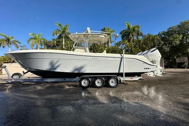Slide: The Image of 2007 Hydra-Sports Vector 3300 CC boat on trailer, parked outdoors with palm trees. - 3