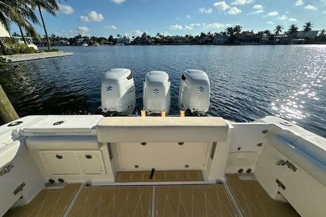 Slide: The Image of 2007 Hydra-Sports Vector 3300 CC boat with triple Suzuki outboard engines on a sunny waterfront. - 8