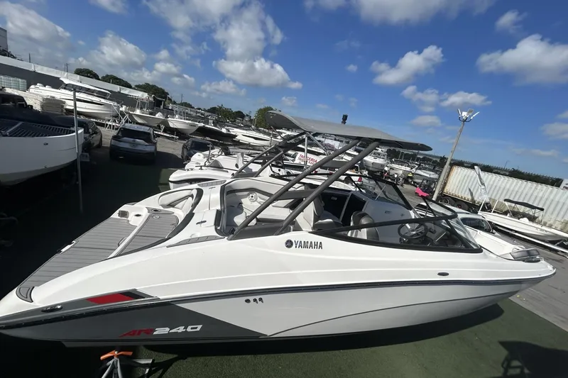 Slide: The Image of 2019 Yamaha AR-240 boat displayed in a marina under a clear blue sky. - 10