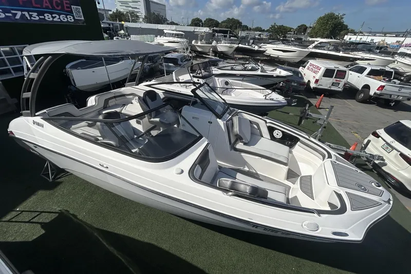 Slide: The Image of 2019 Yamaha AR-240 boat displayed at a marina with other vessels. - 11