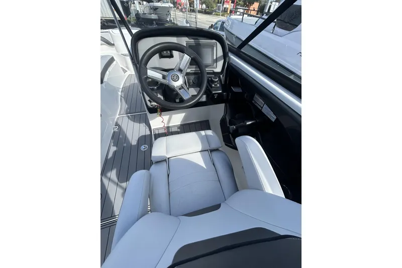 Slide: The Image of 2019 Yamaha AR-240 boat cockpit with steering wheel and seating. - 14
