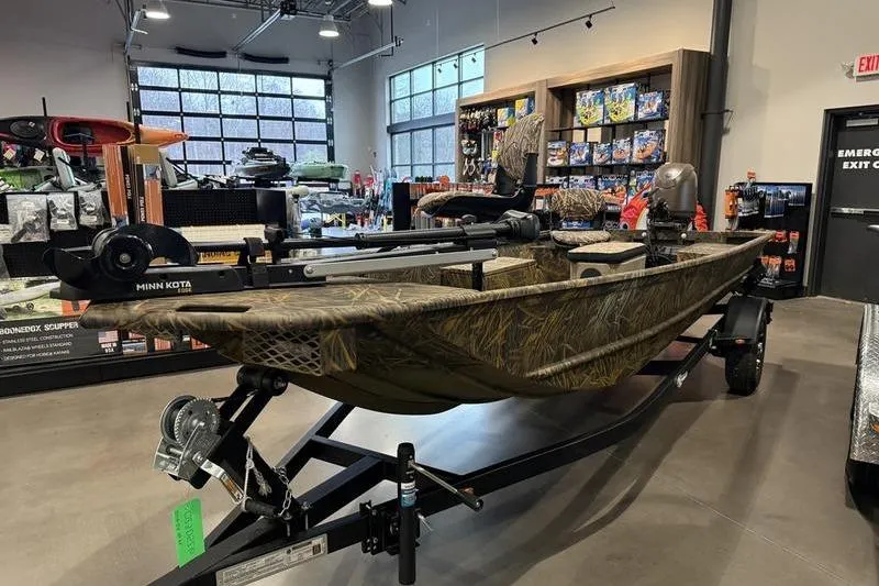 Slide: The Image of 2026 G3 Gator Tough 16 FL boat displayed in a showroom with accessories. - 3