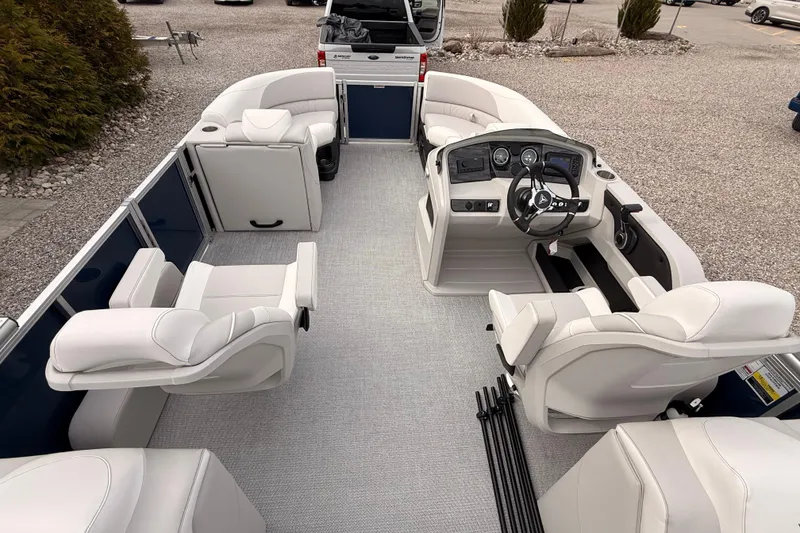 Slide: The Image of 2026 Tahoe Pontoon LTZ Quad Lounger interior with plush seating and modern dashboard. - 15