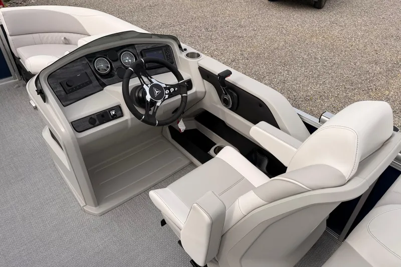 Slide: The Image of 2026 Tahoe Pontoon LTZ Quad Lounger interior with modern steering and comfortable seating. - 16
