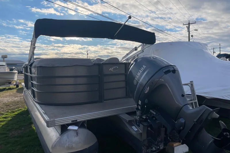 Slide: The Image of 2016 Crest I 220 SLC pontoon boat with Yamaha outboard motor, parked outdoors. - 3