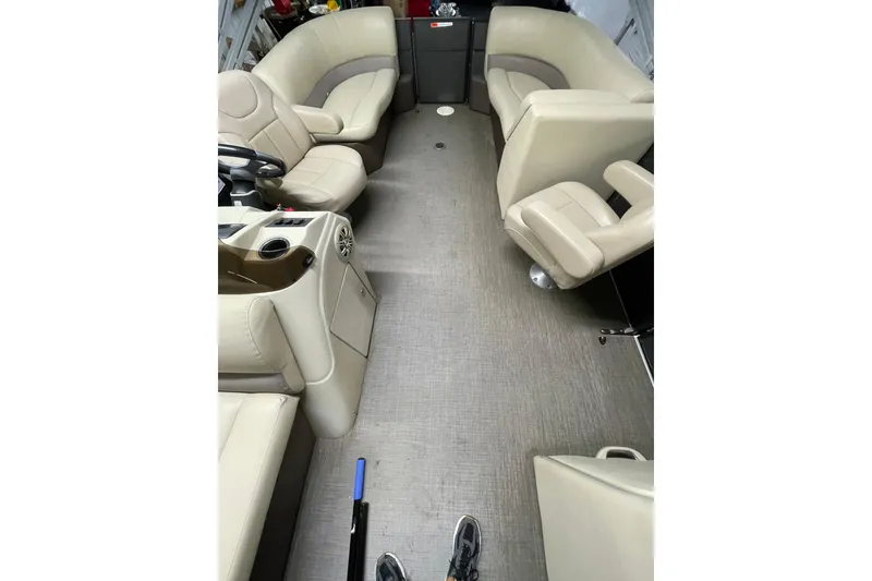 Slide: The Image of Interior of 2016 Crest I 220 SLC pontoon boat with beige seating and steering console. - 6