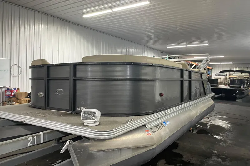 Slide: The Image of 2016 Crest I 220 SLC pontoon boat in indoor storage facility. - 9