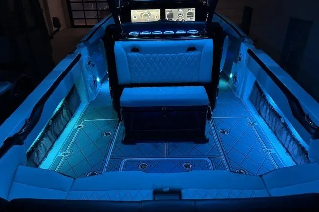 Slide: The Image of 2024 Nor-Tech 340 Sport Center Console with illuminated interior and advanced dashboard technology. - 13