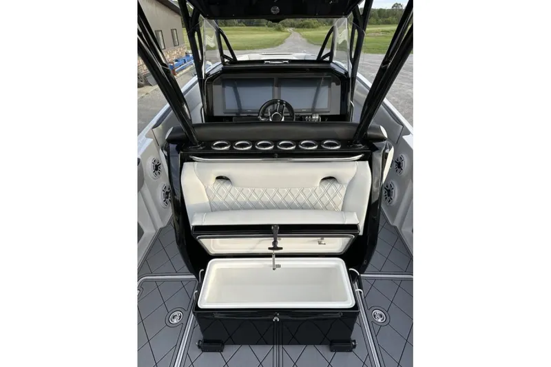 Slide: The Image of 2024 Nor-Tech 340 Sport Center Console interior with luxury seating and modern dashboard. - 16