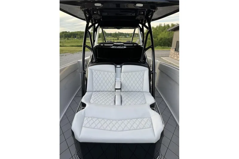 Slide: The Image of 2024 Nor-Tech 340 Sport Center Console with luxurious white seating and sleek design. - 19
