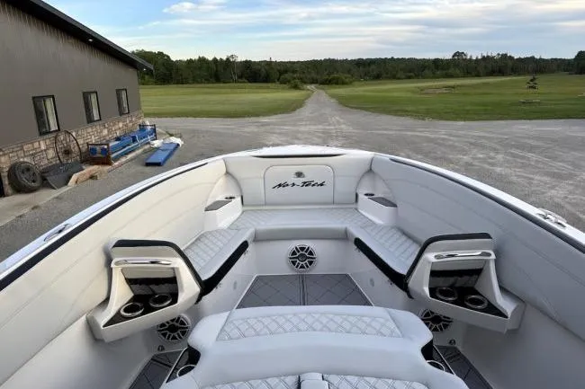 Slide: The Image of 2024 Nor-Tech 340 Sport Center Console boat with luxurious seating and modern design. - 4