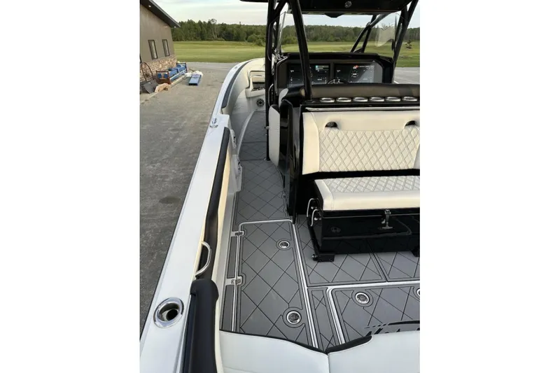 Slide: The Image of 2024 Nor-Tech 340 Sport Center Console boat interior with sleek seating and modern dashboard. - 9