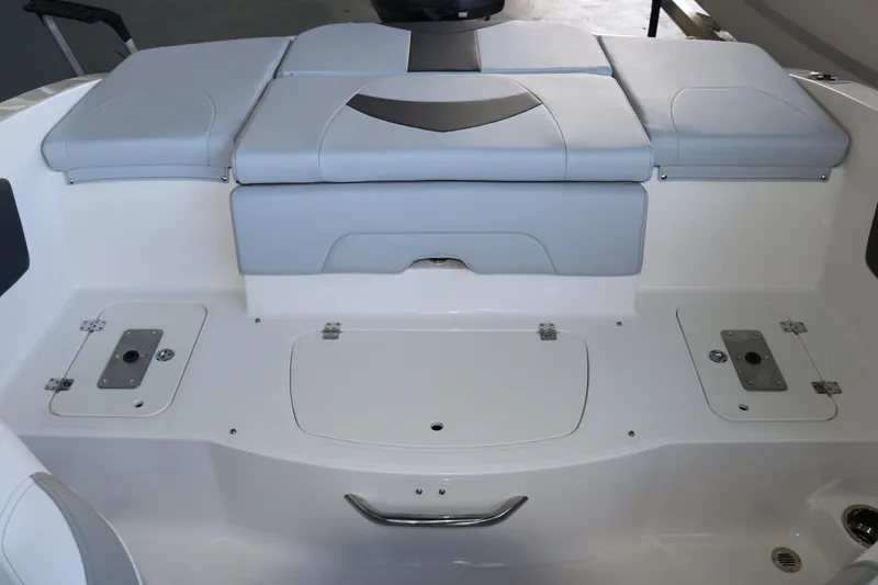 Slide: The Image of 2026 Chaparral 21 SSi Ski & Fish OB boat interior with cushioned seating and storage compartments. - 12