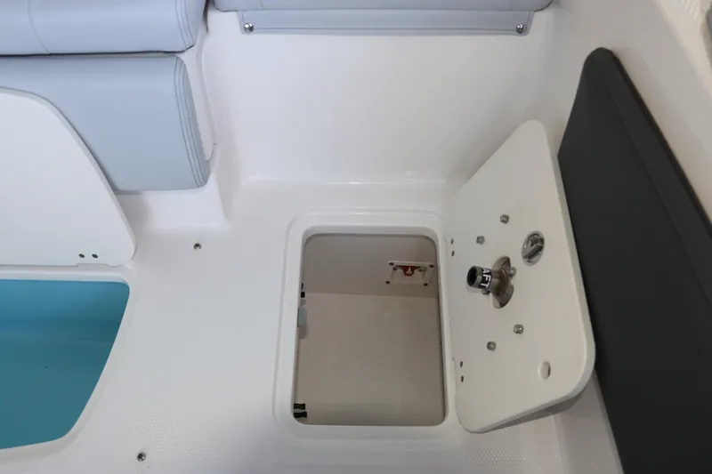 Slide: The Image of 2026 Chaparral 21 SSi Ski & Fish OB boat storage compartment with open hatch. - 16