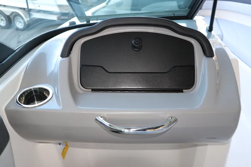 Slide: The Image of 2026 Chaparral 21 SSi Ski & Fish OB dashboard with cup holder and storage compartment. - 20