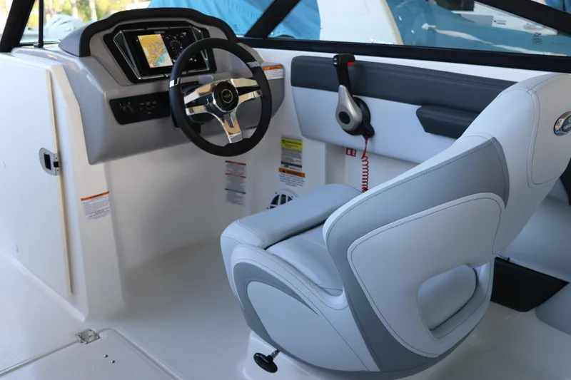 Slide: The Image of Interior of 2026 Chaparral 21 SSi Ski & Fish OB boat, featuring steering wheel and seat. - 26