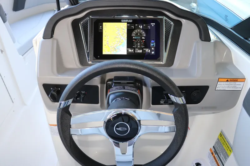 Slide: The Image of 2026 Chaparral 21 SSi Ski & Fish OB dashboard with steering wheel and navigation display. - 29