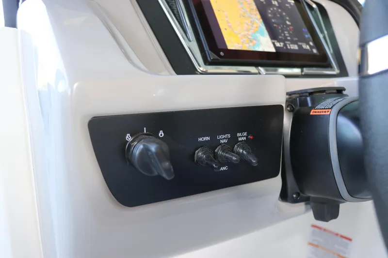 Slide: The Image of Control panel of 2026 Chaparral 21 SSi Ski & Fish OB boat with switches and display. - 31