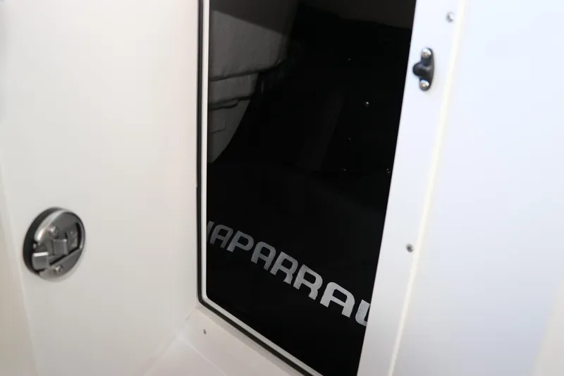 Slide: The Image of 2026 Chaparral 21 SSi Ski & Fish OB interior storage compartment with logo. - 34