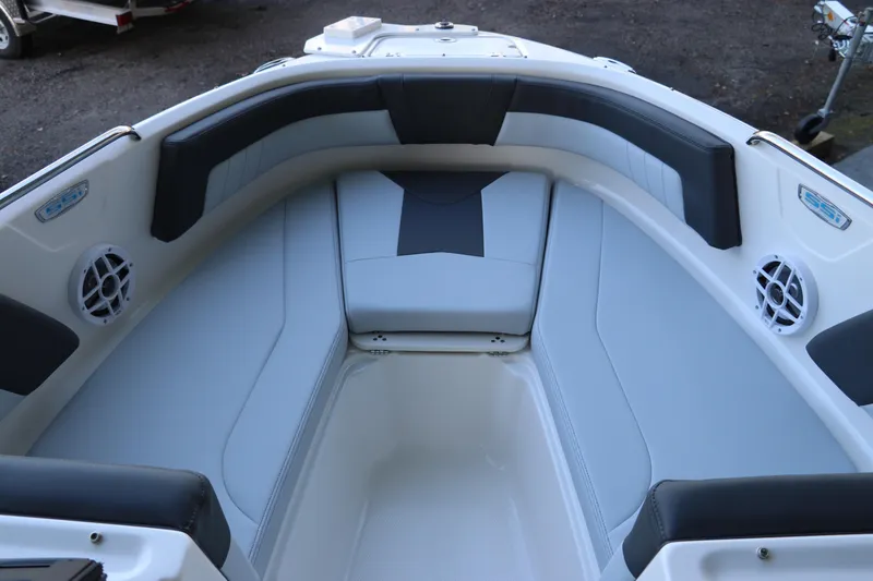 Slide: The Image of 2026 Chaparral 21 SSi Ski & Fish OB boat interior with cushioned seating and speakers. - 35