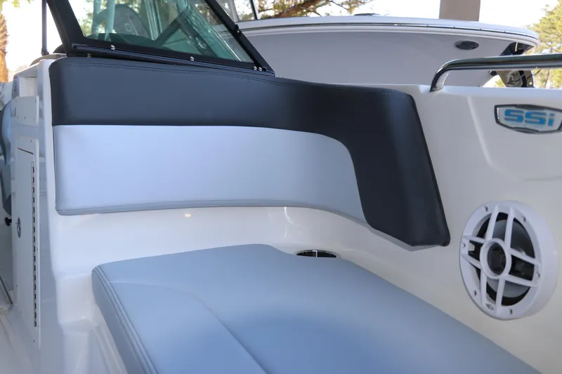 Slide: The Image of 2026 Chaparral 21 SSi Ski & Fish OB boat interior with cushioned seating and speaker. - 37