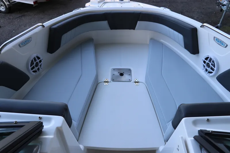 Slide: The Image of 2026 Chaparral 21 SSi Ski & Fish OB boat interior with cushioned seating and speakers. - 38