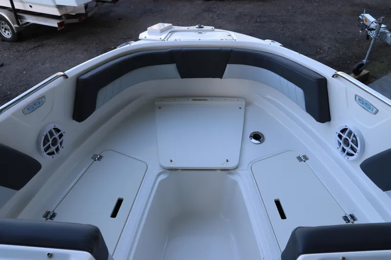 Slide: The Image of 2026 Chaparral 21 SSi Ski & Fish OB boat interior with seating and storage compartments. - 39