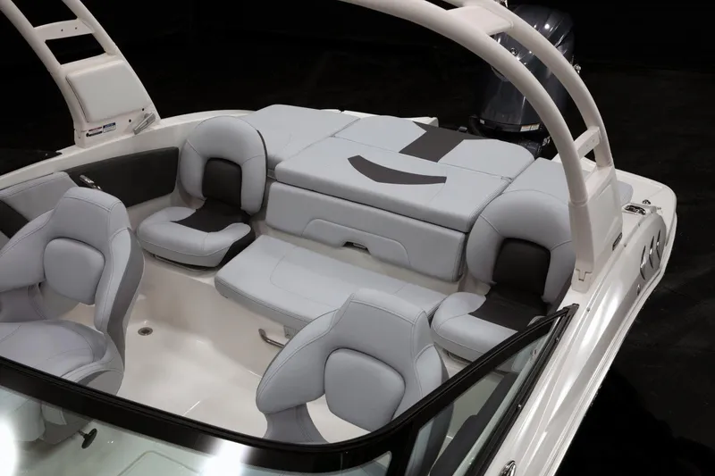 Slide: The Image of 2026 Chaparral 21 SSi Ski & Fish OB boat interior with cushioned seating and storage compartments. - 7