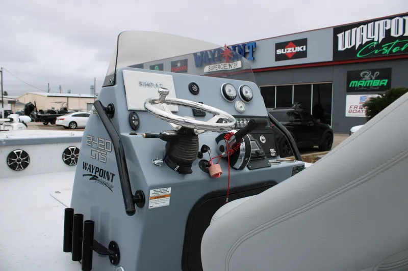 Slide: The Image of 2021 Blazer 2420 GTS boat console at Waypoint dealership, featuring steering and controls. - 11