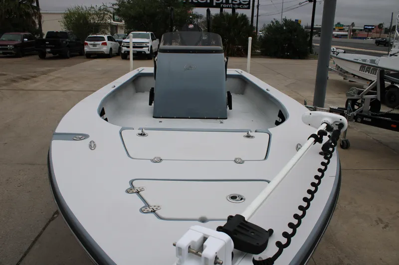 Slide: The Image of 2021 Blazer 2420 GTS boat, front view, parked on concrete lot with vehicles in background. - 14