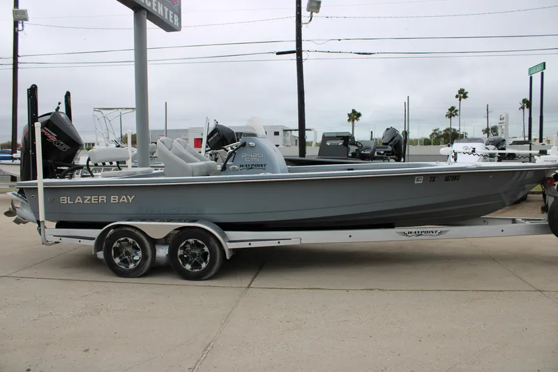 Slide: The Image of 2021 Blazer 2420 GTS boat on trailer, displayed outdoors. - 4
