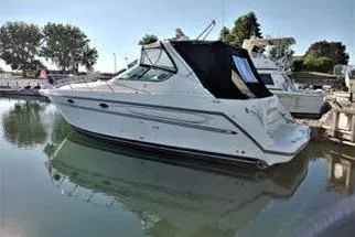 The Image of 1999 Maxum 3700 SCR yacht docked in a serene marina setting. - 0
