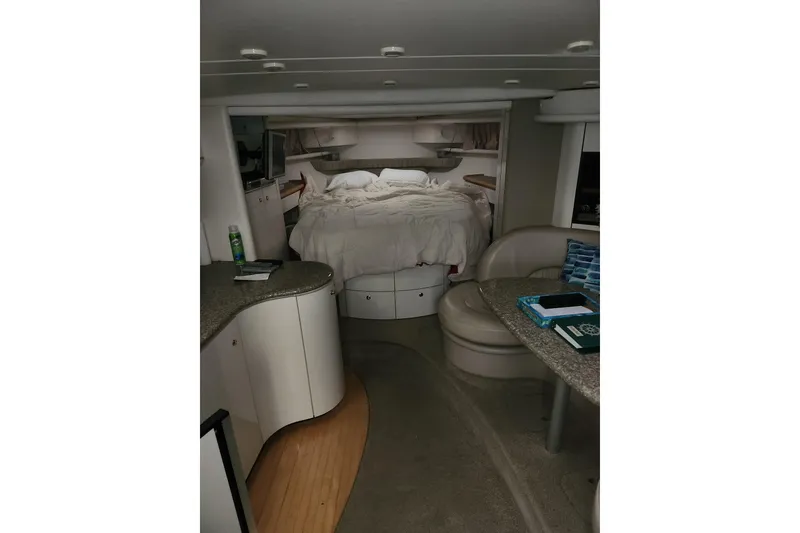 Slide: The Image of Interior of 1999 Maxum 3700 SCR yacht with cozy bed and seating area. - 11