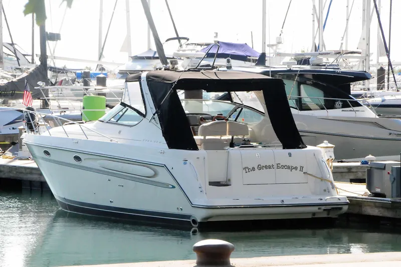 Slide: The Image of 1999 Maxum 3700 SCR yacht docked in marina, named "The Great Escape II". - 3