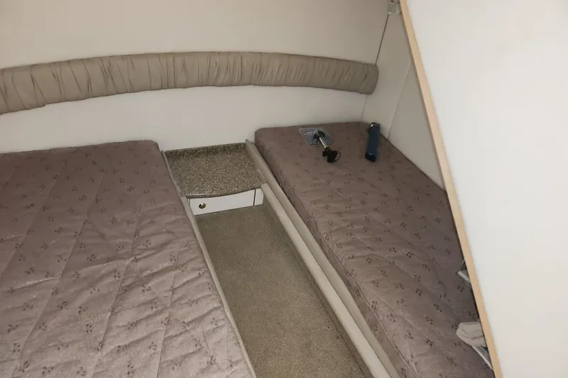 Slide: The Image of 1999 Maxum 3700 SCR cabin interior with twin beds and beige upholstery. - 8