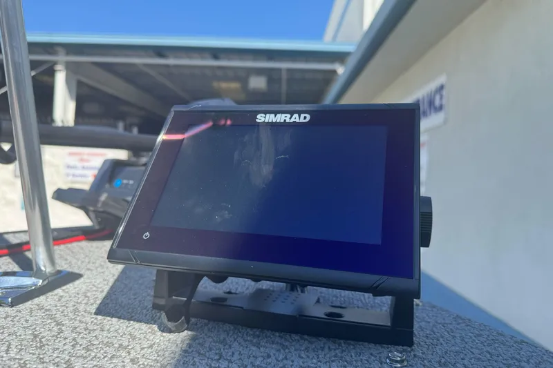 Slide: The Image of Simrad display on 2026 Lund 1650 Rebel XL SS boat, outdoor setting. - 12