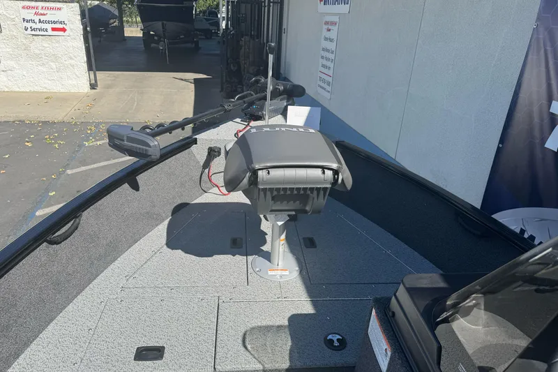 Slide: The Image of 2026 Lund 1650 Rebel XL SS boat interior with trolling motor and seating. - 14