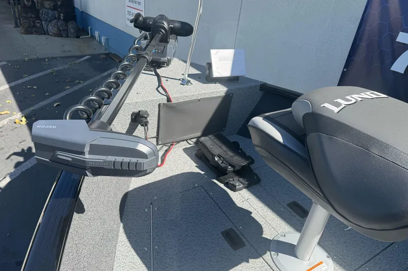 Slide: The Image of 2026 Lund 1650 Rebel XL SS boat interior with seating and trolling motor. - 15