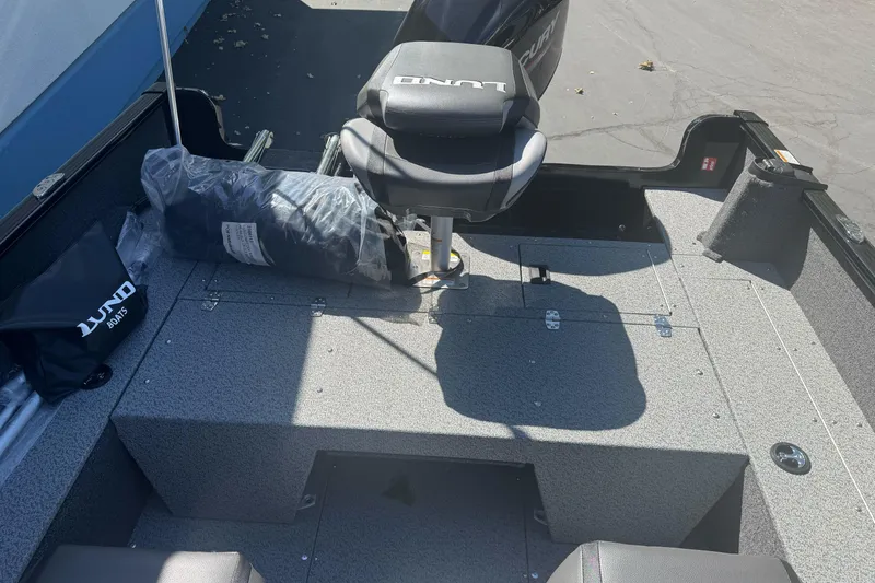 Slide: The Image of 2026 Lund 1650 Rebel XL SS boat interior with seating and storage compartments. - 17