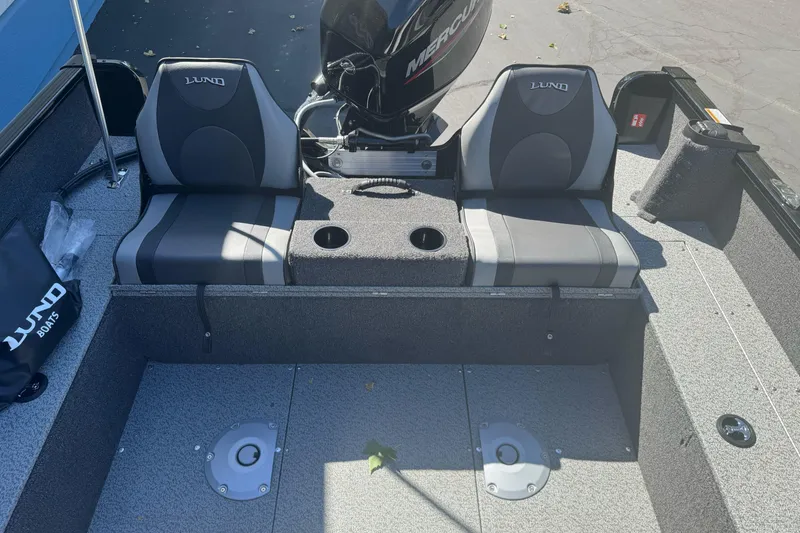 Slide: The Image of 2026 Lund 1650 Rebel XL SS boat interior with dual seats and Mercury engine. - 18