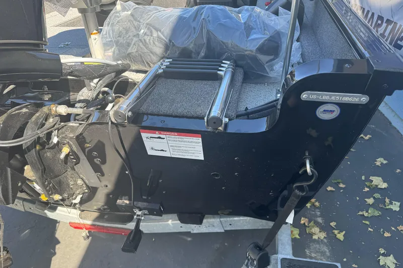 Slide: The Image of 2026 Lund 1650 Rebel XL SS boat transom with motor and ladder details. - 9