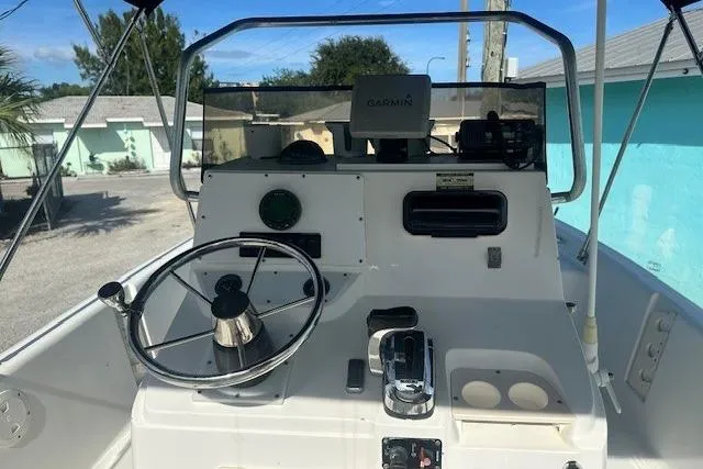 Slide: The Image of 1999 Mako Pro Skiff 21 CC boat console with steering wheel and Garmin navigation system. - 10