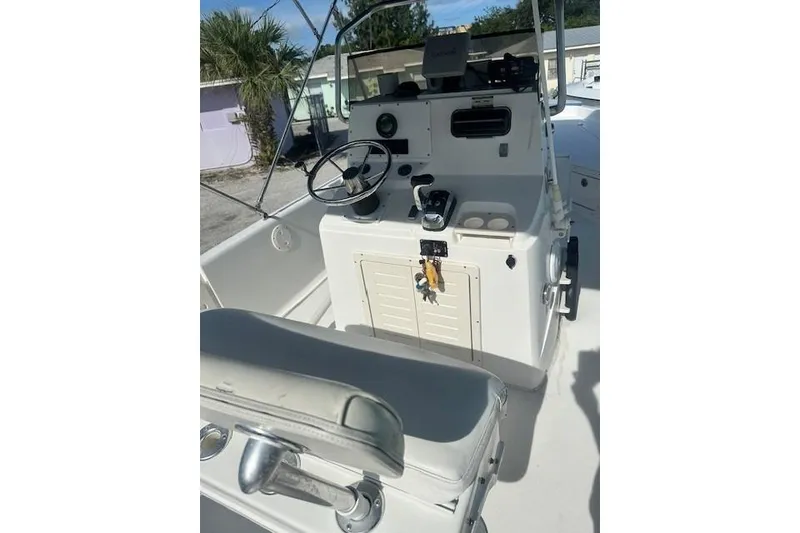 Slide: The Image of 1999 Mako Pro Skiff 21 CC boat console with steering wheel and controls. - 11