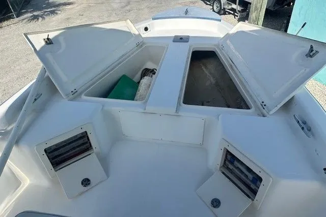 Slide: The Image of 1999 Mako Pro Skiff 21 CC boat with open storage compartments and deck view. - 6