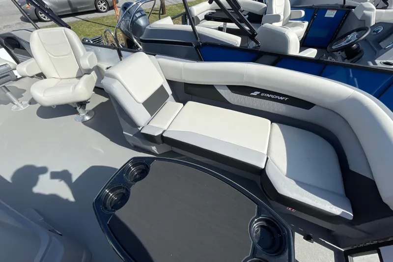 Slide: The Image of 2026 Starcraft VX 20 FD boat interior with white seating and cup holders. - 12